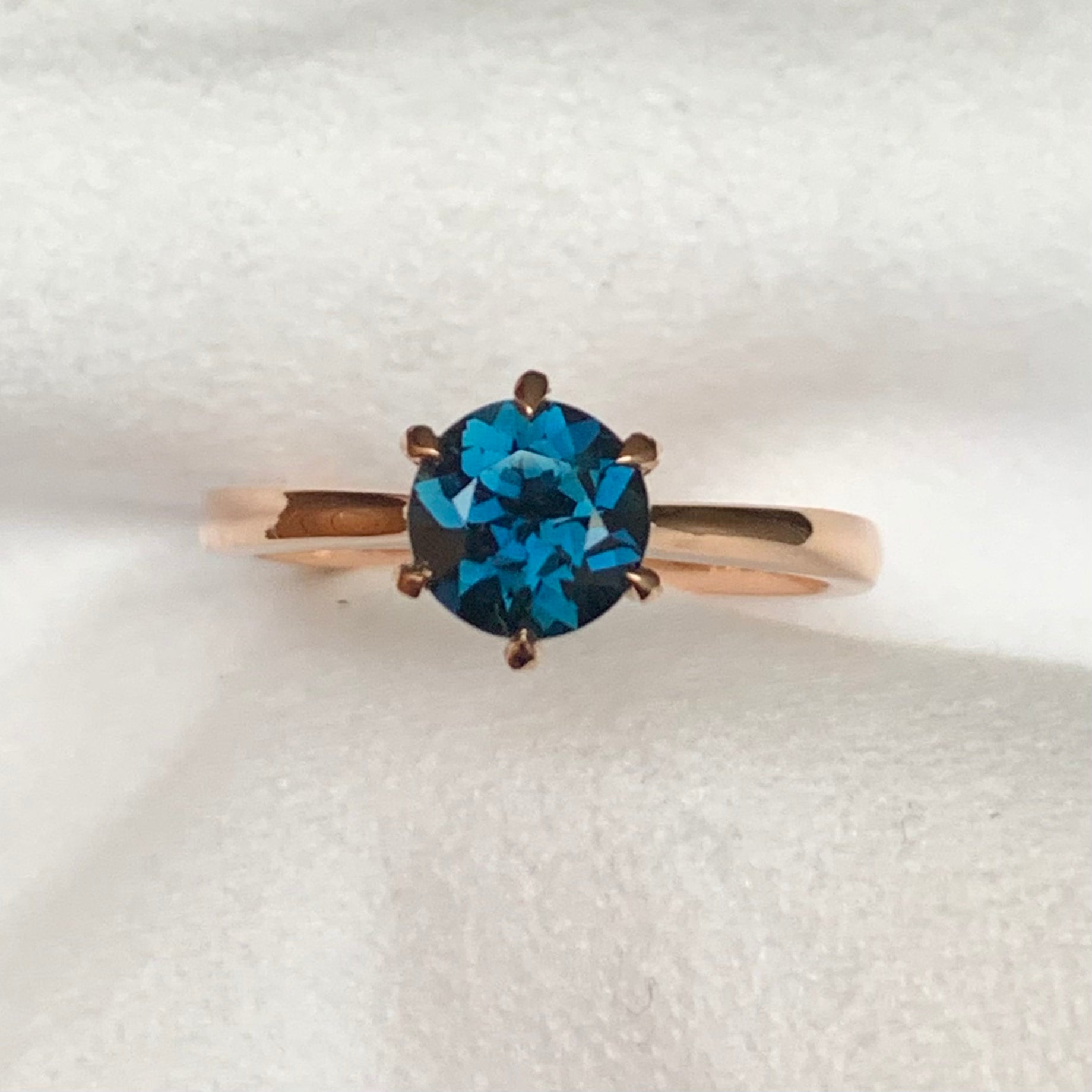 This 14ct Rose Gold Solitaire Chloe Ring is beautifully complimented by a 1.09ct teal blue Australian Sapphire, the stone is set with six eagle shaped claws in Rose gold.  The Sapphire measures 6.14ct and is 1.09cts   The ring is size L & can be sized to sizes I-R   Made with recycled metal in Sydney   Ethically sourced Gemstones